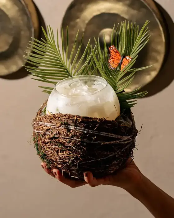 Tiki cocktail held up with palm leaves, shot in-house