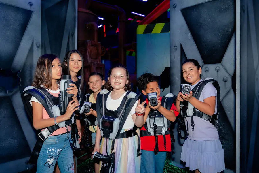 Kids in laser tag gear at a birthday party