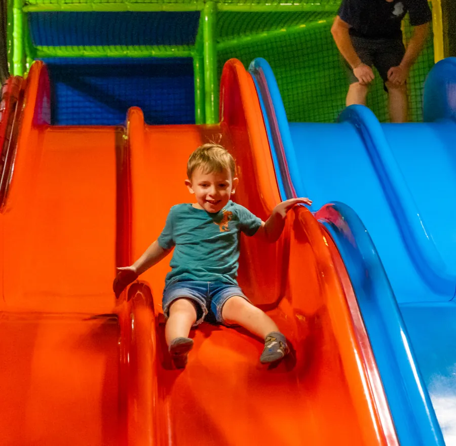 A child on the slide at Off the Wall Kidz