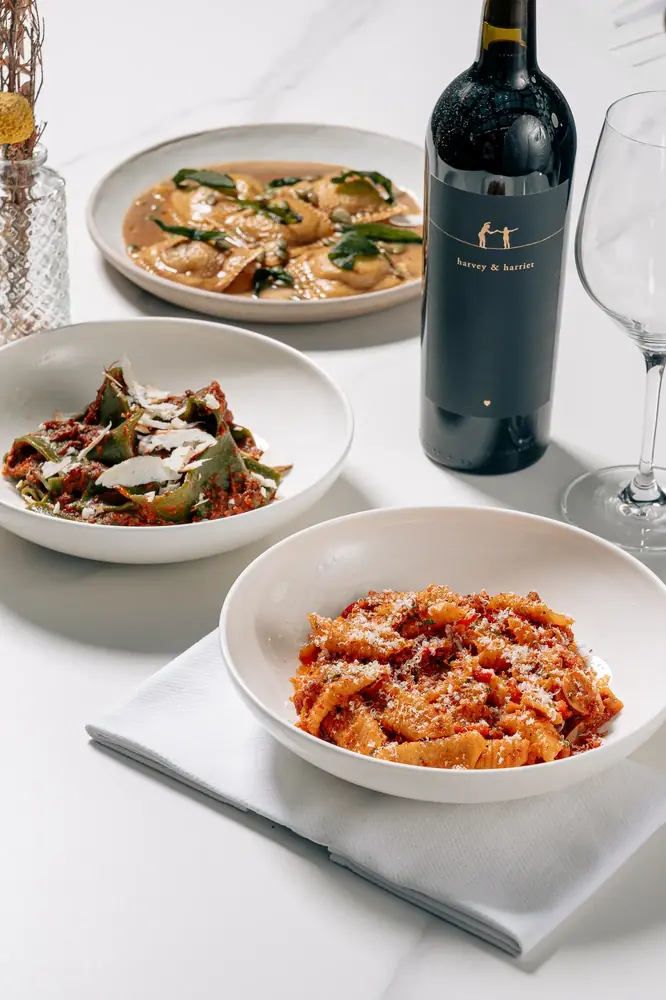 Pasta and wine table spread, restaurant photography